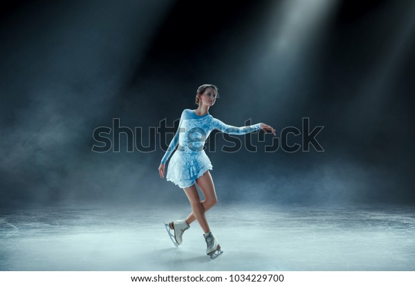 girl figure skating at ice\
arena