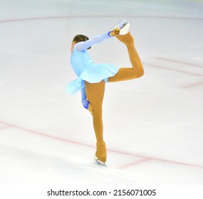 Girl figure skating rolls on a skating rink with artificial ice