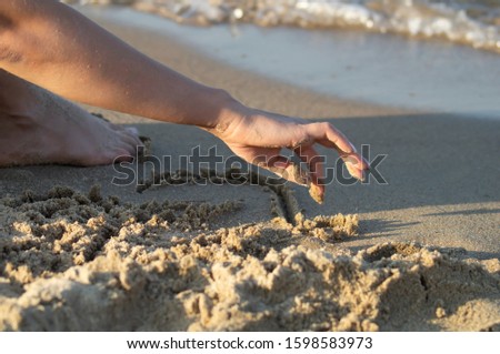 Similar – Hand im Sand Lifestyle