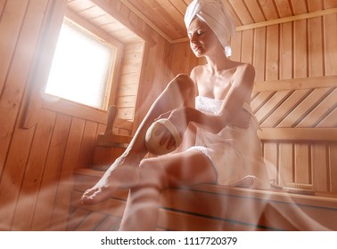 Girl In A Finnish Sauna Doing Skin Peeling