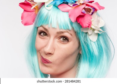 Girl with flower headband and crazy wig shot in the studio on white background.
