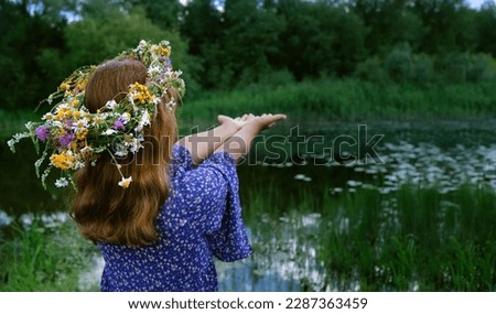 girl in flower wreath outdoor, abstract natural green background. rear view. Floral crown, symbol of summer solstice. ceremony for Midsummer, wiccan Litha sabbat. pagan slavic holiday Ivan Kupala Foto d'archivio © 