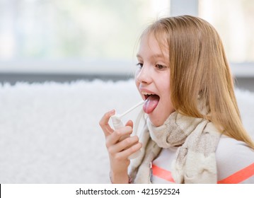 Girl With Flu Using Medical Spray