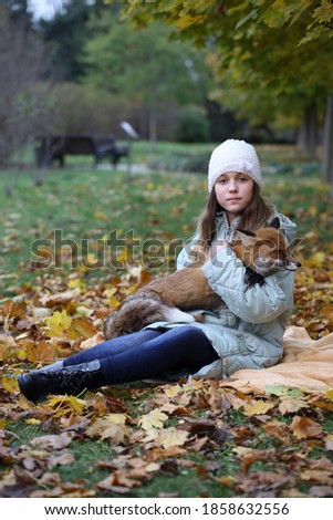 Similar – Foto Bild Herbstportrait eines glücklichen Kindes Mädchens im Garten sitzend