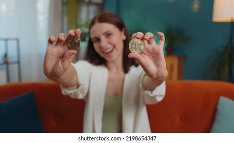 Girl Freelancer Hold Two Gold BTC Coins At Home Successful Developer Programmer. Woman Stock Trader Earning Bitcoins After Online Monitoring Trading Operations. Increasing Wealth, Financial Prosperity