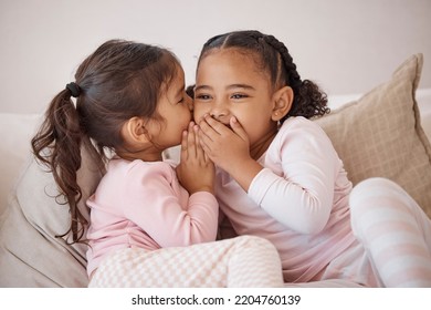 Girl, friends or children whisper secret to best friend on home sofa while relax together on play date. Communication, conversation and sisters or youth kids gossip at fun slumber party or sleepover - Powered by Shutterstock