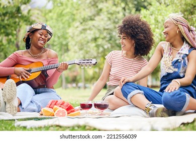 Girl Friends, Music And Guitar At Picnic With Fruit, Drinks And Happy Laughter In Nature. Friendship, Song And Party On Grass, Group Of Black Women Having Lunch Together On Blanket In Park In Africa.