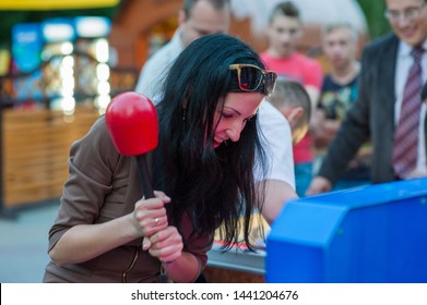 Girl Fun Playing Slot Machines. Children And Adults Play Slot Machines, Attractions In The Mall. Families With Children Have Fun And Play Arcade Games On Computer Machines.