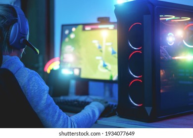 Girl gamer playing strategy game online - Soft focus on headphones