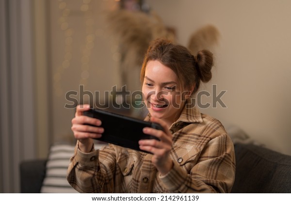 Girl\
gamer with a portable game console. Video games, computer games,\
cyberspace, esports, virtual reality, youth\
culture.