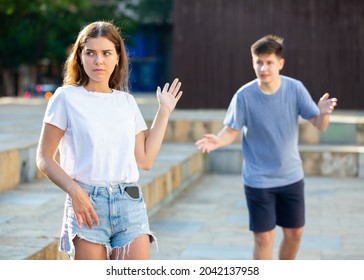 Girl Gesturing Stop To Man Flirting With Her On Street