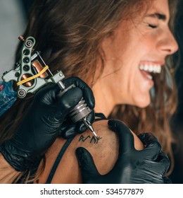 Girl Getting A Tattoo. Toned Image