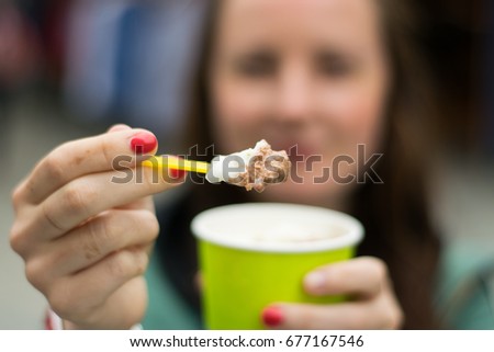 Girl give ice cream on the spoon