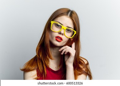 A girl with glasses looks at the camera