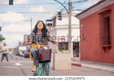 A girl goes to school by bicycle with her books in the basket. Stock foto © 