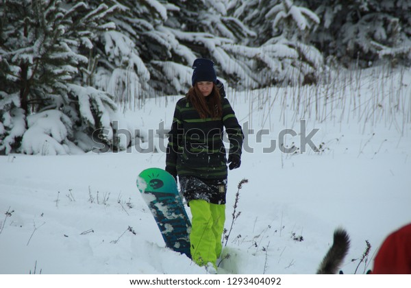 The girl goes snowboarding tied to the car.\
Winter Fun. Adult games. Winter\
fun.