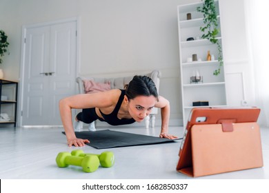 The Girl Goes In For Sports At Home. Online Fitness Workout.