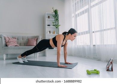 The Girl Goes In For Sports At Home. Online Fitness Workout.