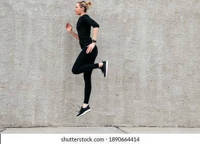 Girl goes in for sports on the street, Running on the spot, Blac
