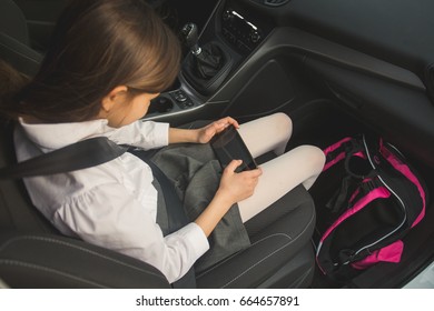 Girl Going To School By Car And Using Mobile Phone