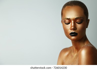 Girl With Golden Paint On Her Face. Black Lipstick On Lips. Creative Make Up, Face Art, Body Art