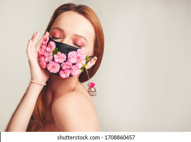 Girl With Gorgeous Long Hair In An Antiviral Mask. Fashion Photo On The Cover Of The Magazine. Pandemic, Virus, Coronavirus, Masked Girl Spring Has Come. Spring Fashion, Model In A Mask Of Flowers