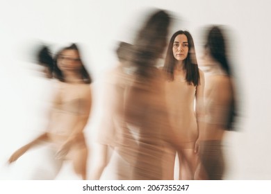 The Girl Got Lost In The Crowd. Black And White Photo Of A Girl In Underwear. One Person In Focus. The Crowd Is In A Hurry On Business