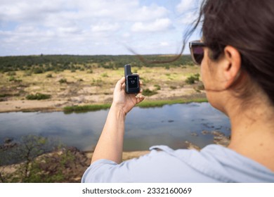 Girl with GPS Device in the Wilderness