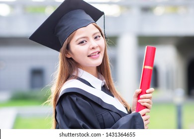 Girl gratuate smile happily at campus with diploma