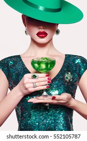 Girl In A Green Hat With A Cocktail In Hand. Green Party Dress. Absinthe Ice.