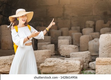 Girl Guide Or History Teacher Tells Students Or Tourists A Lecture About Ancient Greece In The Acropolis. Education And Tourism Concept