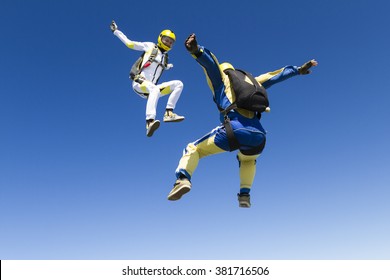 A Girl And A Guy Skydivers Perform Pieces In Free Fall.