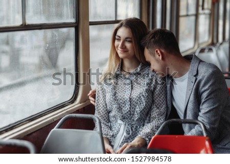 
A girl and a guy walk around the city. They kiss and hold hands