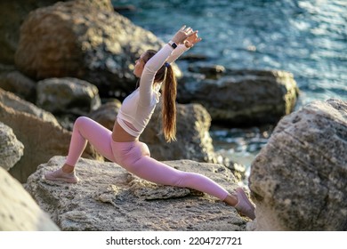 Girl Gymnast Trains On The Beach By The Sea. Photo Series