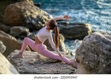 Girl Gymnast Trains On The Beach By The Sea. Photo Series