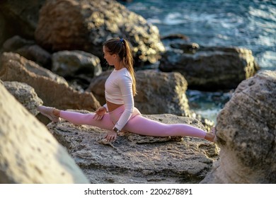 Girl Gymnast Trains On The Beach By The Sea. Photo Series