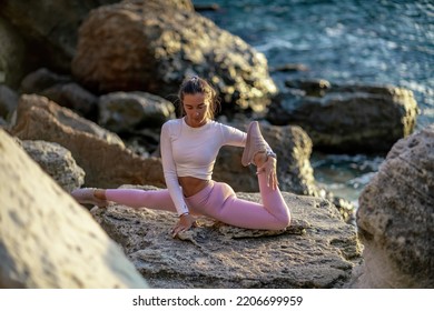 Girl Gymnast Trains On The Beach By The Sea. Photo Series