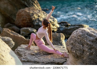 Girl Gymnast Trains On The Beach By The Sea. Photo Series