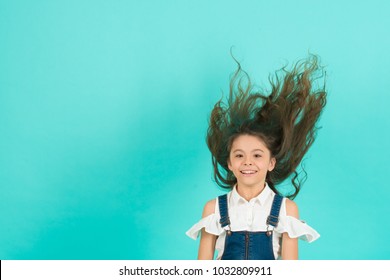 Girl With Hair Blowing In Wind On Blue Background, Copy Space