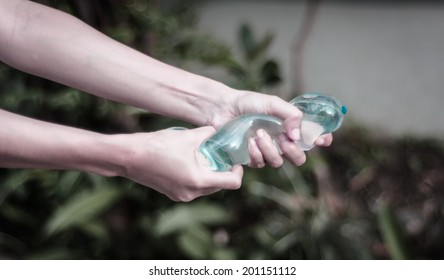 Girl Hand Holding Water Balloon With Retro Filter At Blur Natural Background