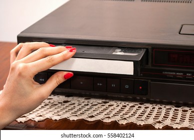 Girl Hand Inserting Blank VHS Cassette In Old Video Recorder