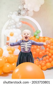 Girl In Hand Made Halloween Costume Screaming At A Balloon Arch Photobooth