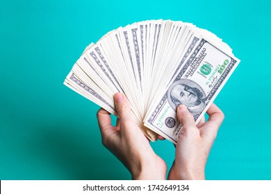 Girl Hands Holding A Batch Of Dollars
