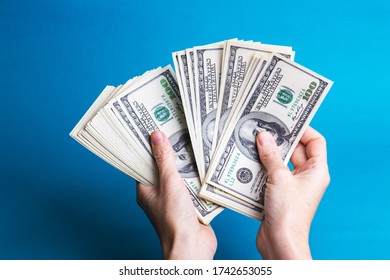 Girl Hands Holding A Batch Of Dollars
