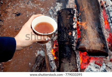 girl hands holding cup of tea in winter                