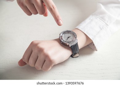 Girl hands with wrist watch on white desk. - Shutterstock ID 1393597676
