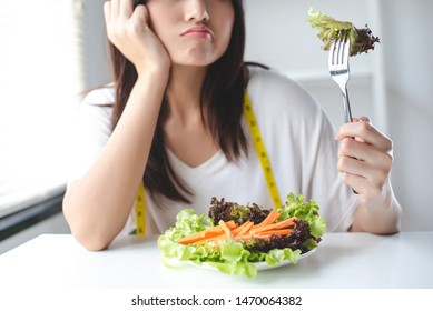 The Girl Has A Boring Expression When She Eats Vegetables. She Wants To Eat Delicious Food. Diet, Clean Food, Healthy Food Concept.
