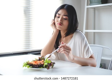 The Girl Has A Boring Expression When She Eats Vegetables. She Wants To Eat Delicious Food. Diet, Clean Food, Healthy Food Concept.
