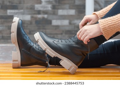A girl has winter boots on her feet. The concept of warm shoes. Lifestyle. - Powered by Shutterstock