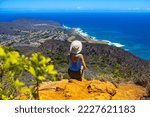girl in a hat enjoys the oahu panorama from the top of the famous koko crater railway trailhead, oahu, hawaii, hiking in hawaii, holiday in hawaii